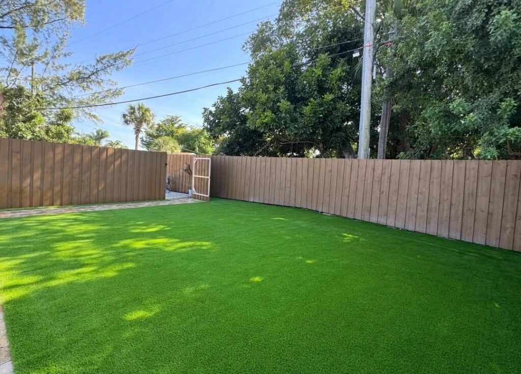 Artificial turf backyard installation with privacy fence