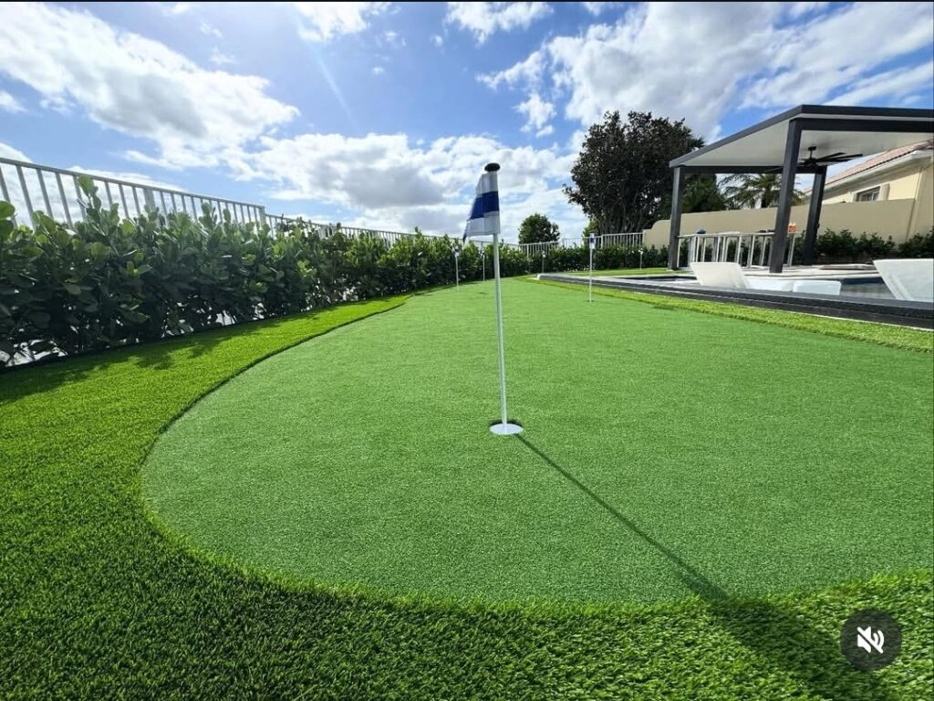 Closeup of artificial turf backyard putting green installation